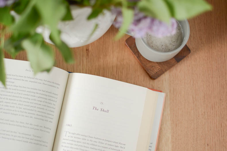 open book with flowers and drink